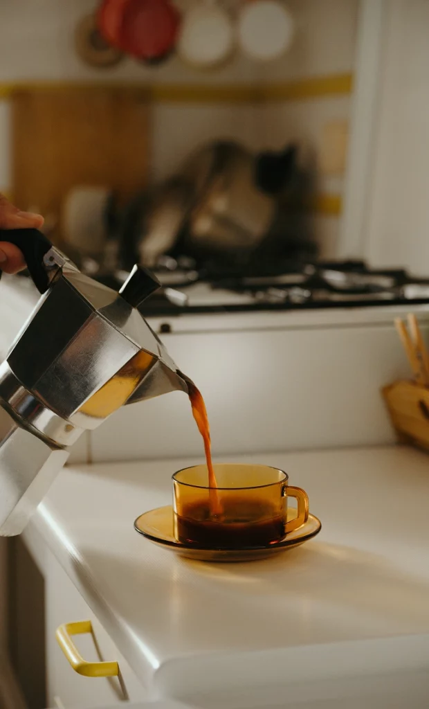 moka pot brewing coffee on stovetop
